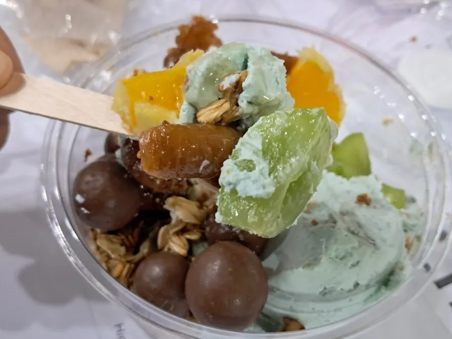 Mixing fruit and choco balls into the Greek yogurt