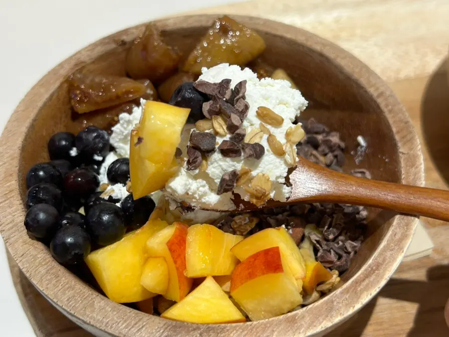 Yogurt bowl topped with cacao nibs and granola