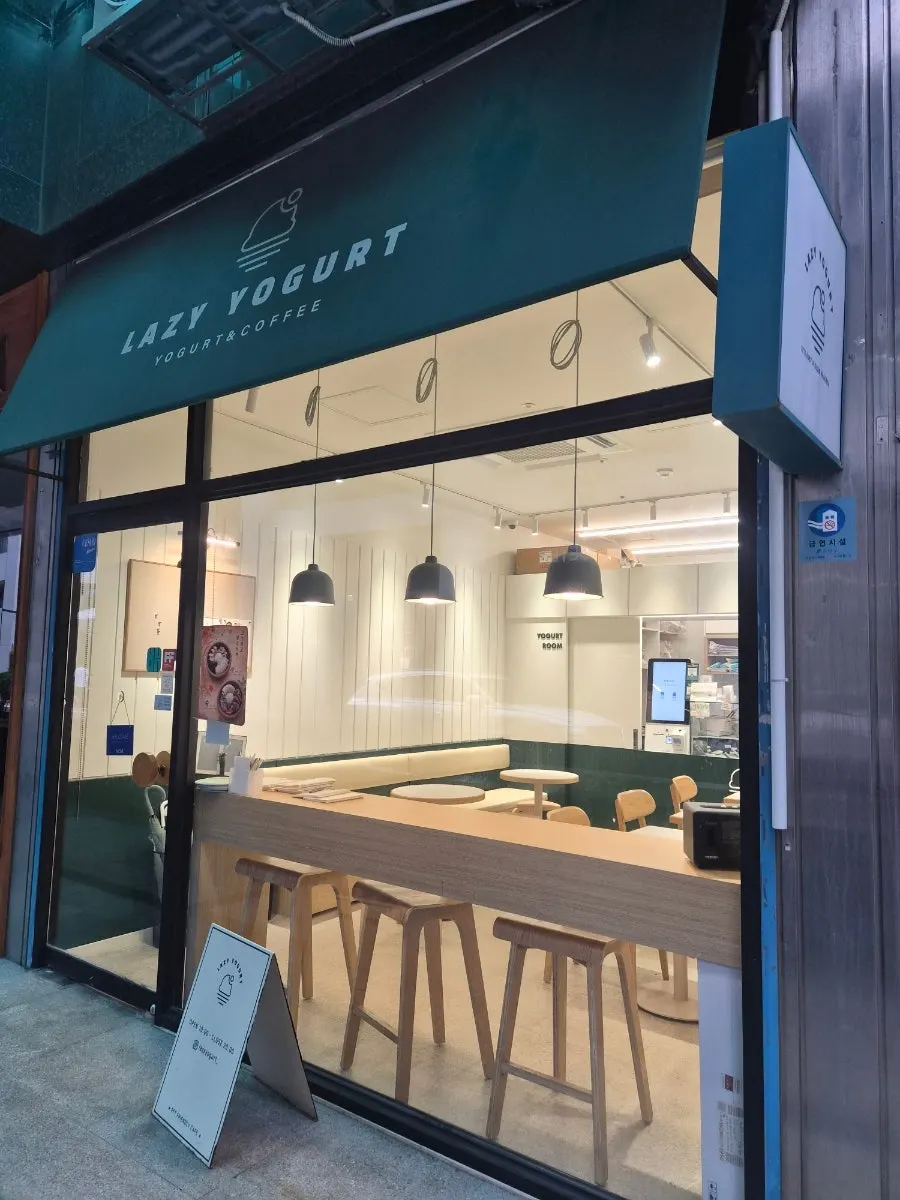 Green awning and LAZY YOGURT sign