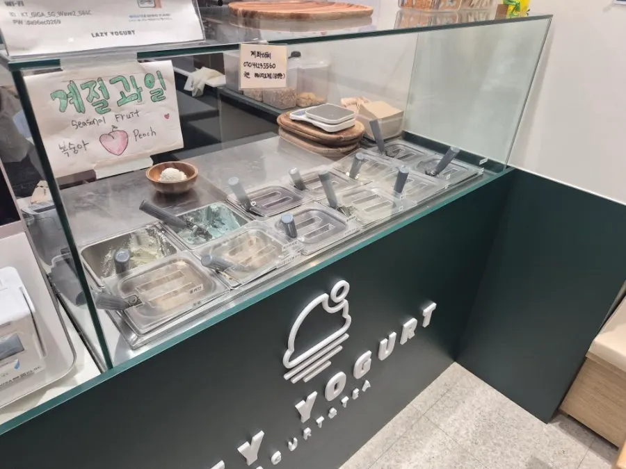 Ordering counter displaying various yogurt flavors