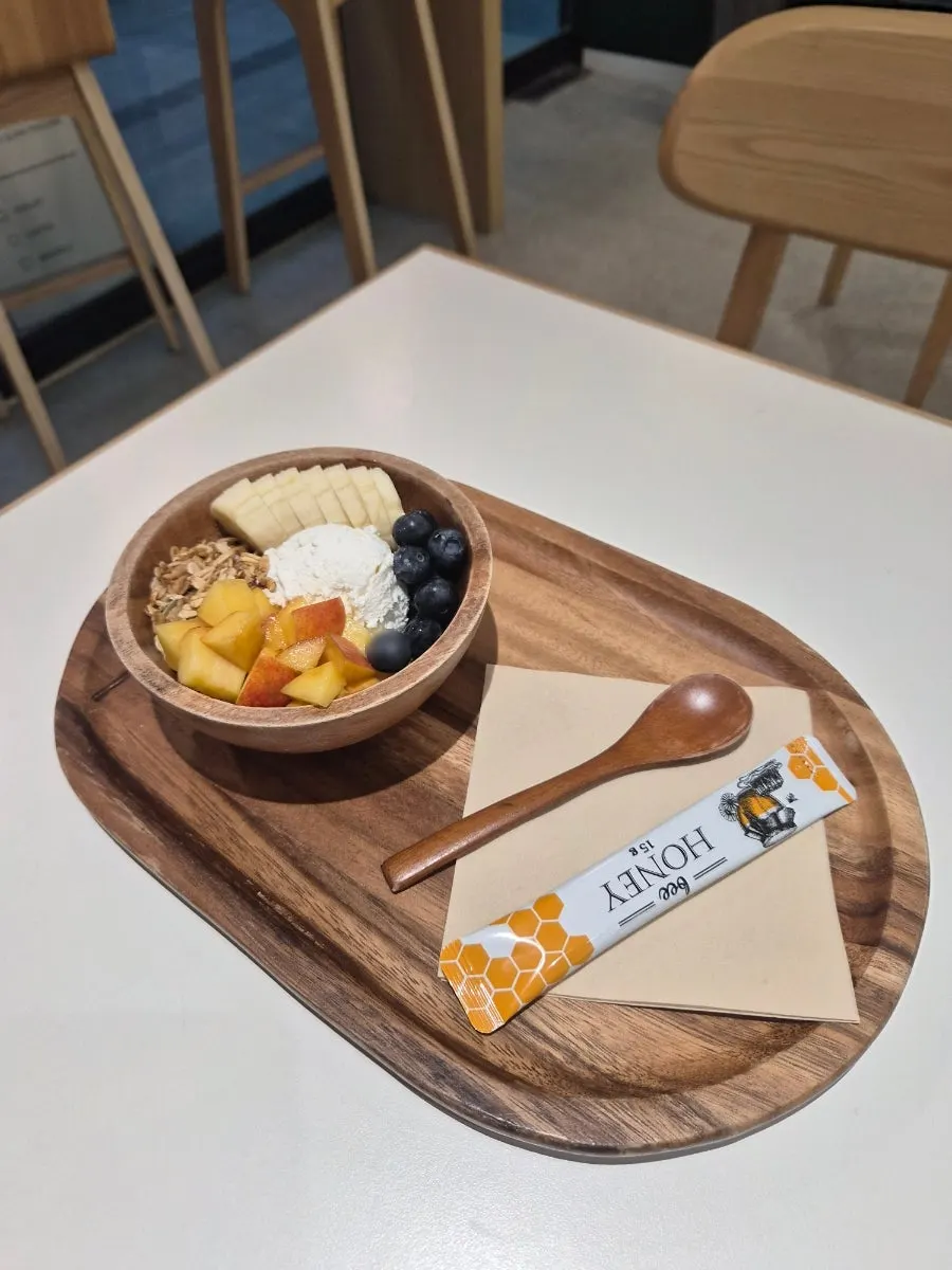 Spoonful of yogurt with granola and blueberries