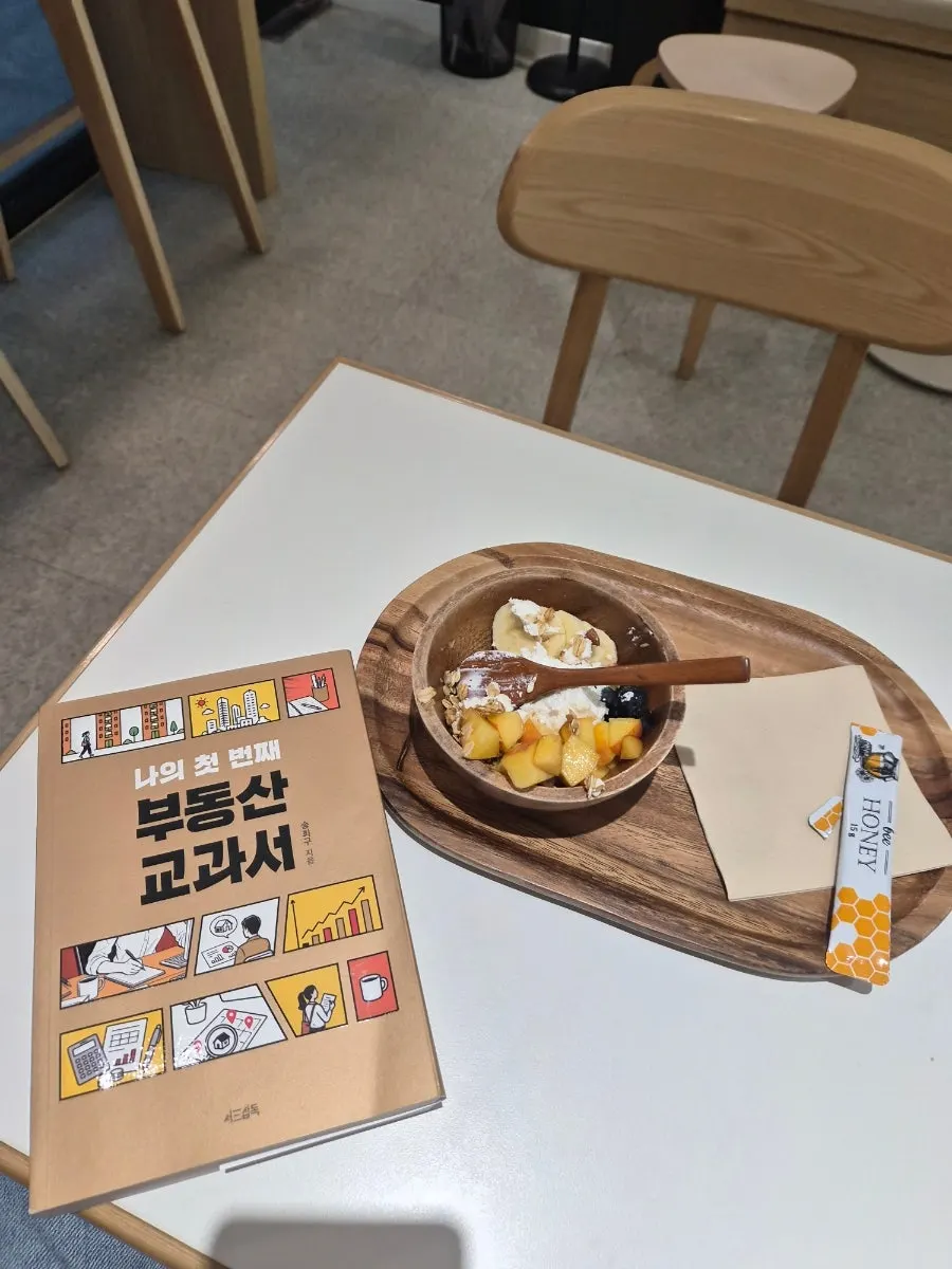 Reading a book with yogurt in a quiet weekend café