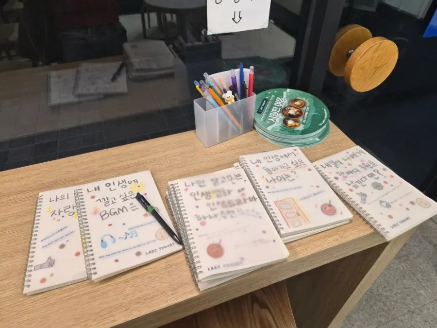 Guestbook corner at Lazy Yogurt with pens and notebooks
