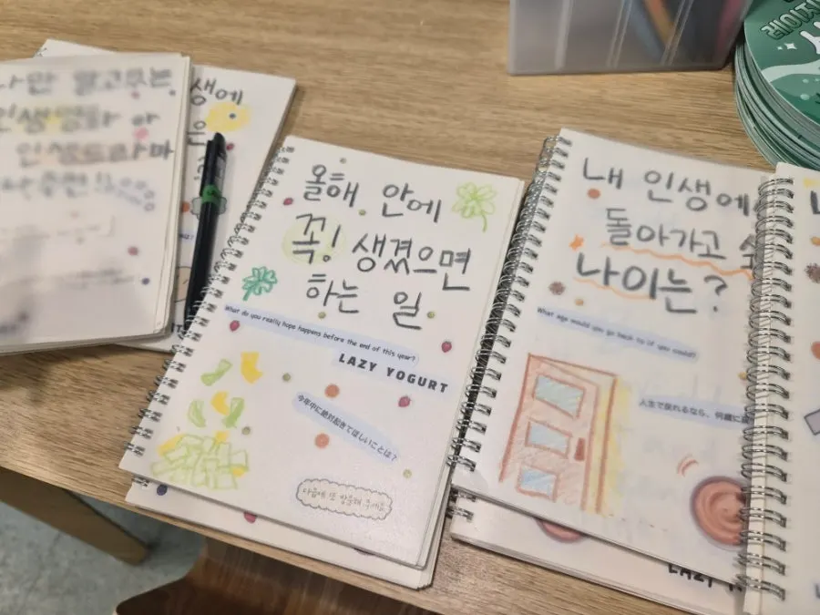 Several guestbook notebooks filled with written questions