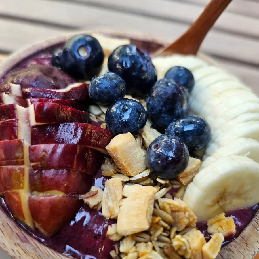 Acai bowl topped with coconut chips and oats