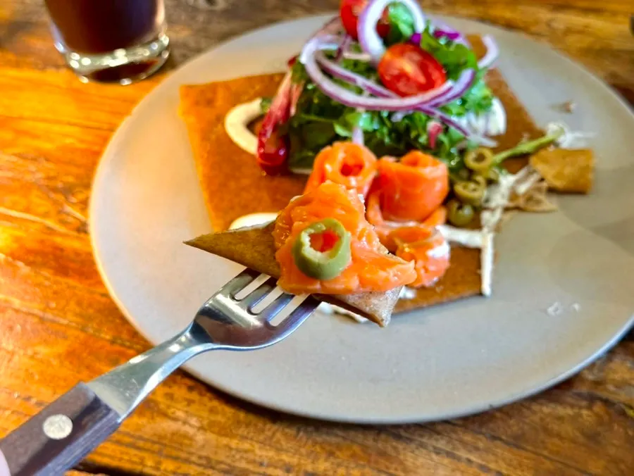 Salad and carrot rapée served alongside the galette