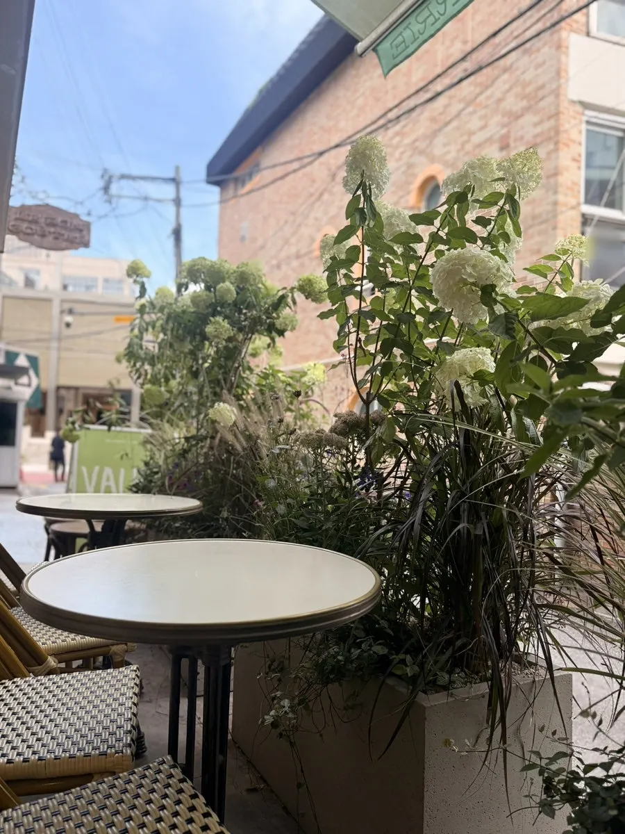 Flower-filled terrace seating at Le Bon Goûter