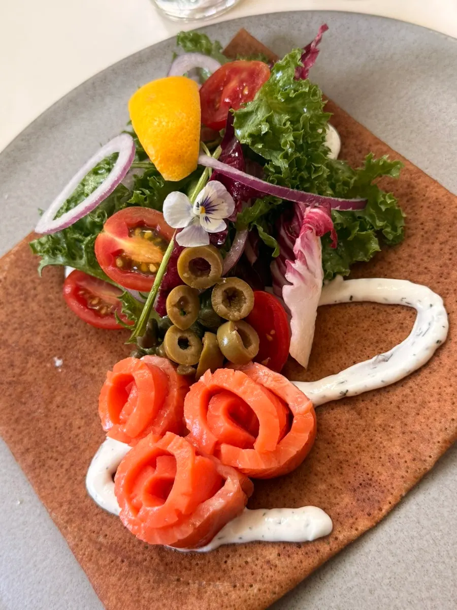 Salmon galette and banana brûlée galette on the terrace table