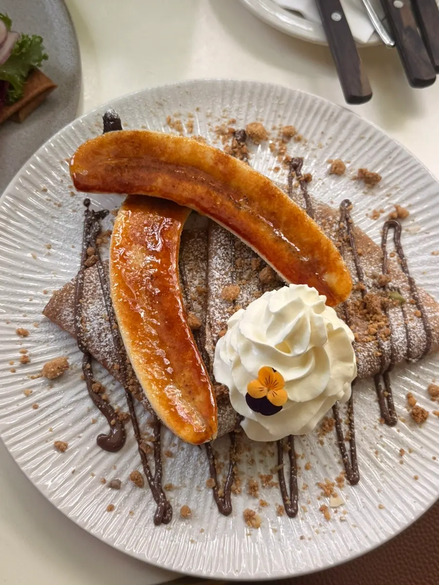 Two galette plates from Le Bon Goûter topped with flowers