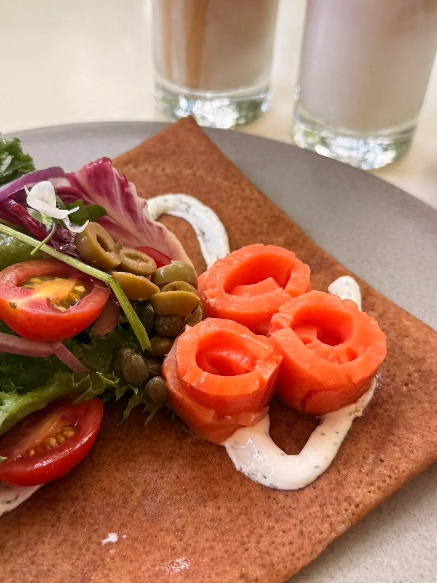Salmon galette topped with smoked salmon and salad