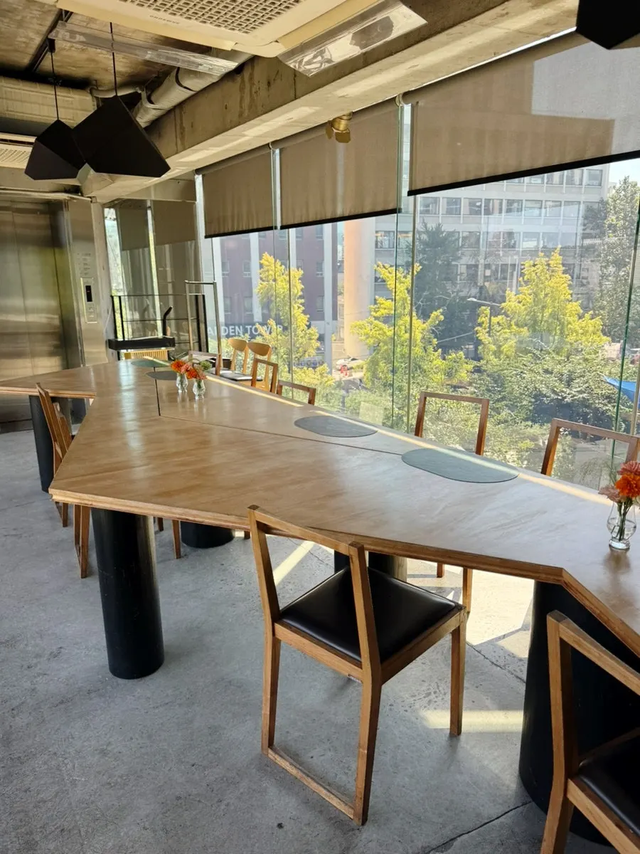 Le Cochon's interior with seating arranged along the floor-to-ceiling windows