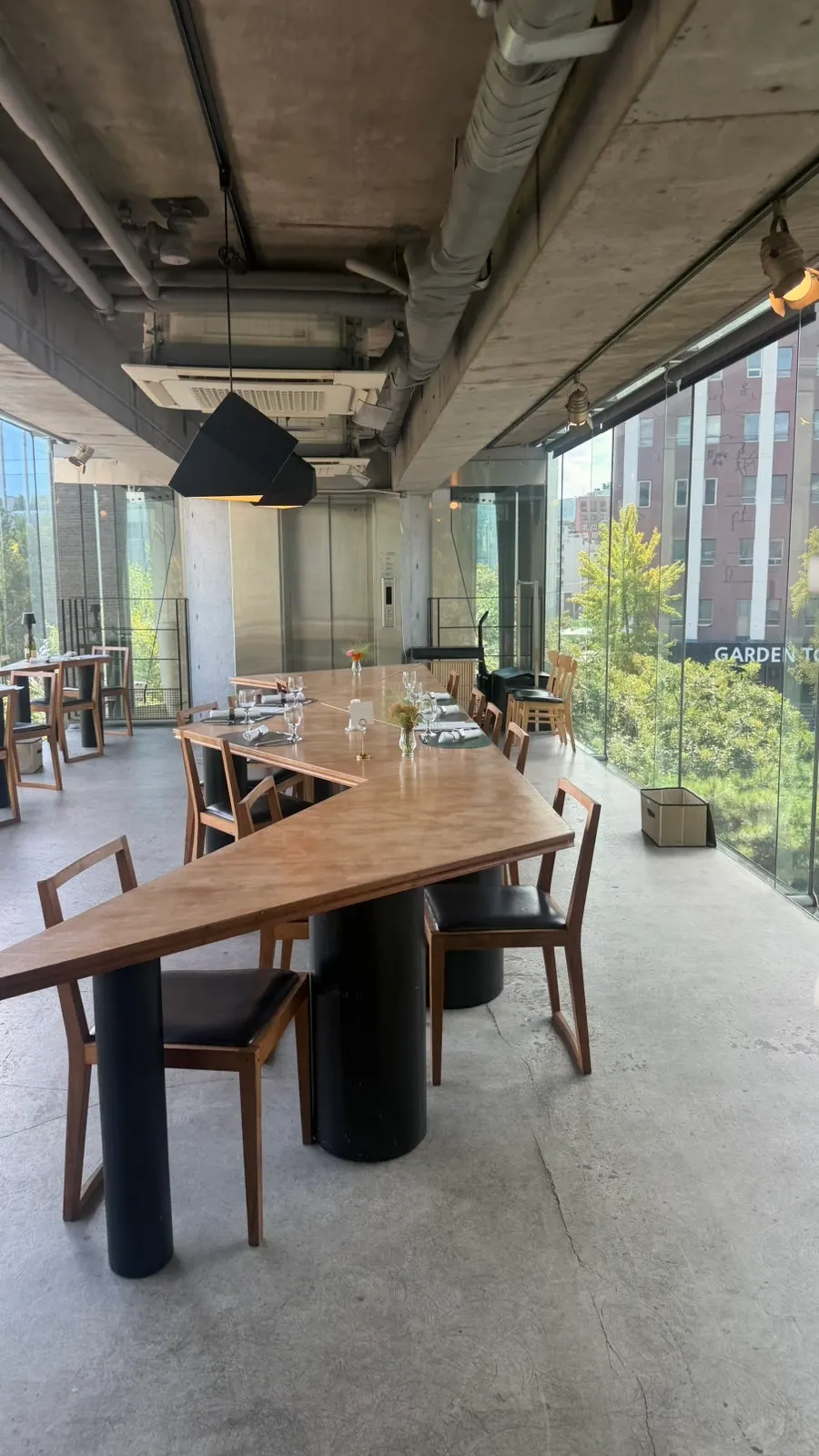 Natural light streaming in through Le Cochon's floor-to-ceiling windows onto the seating
