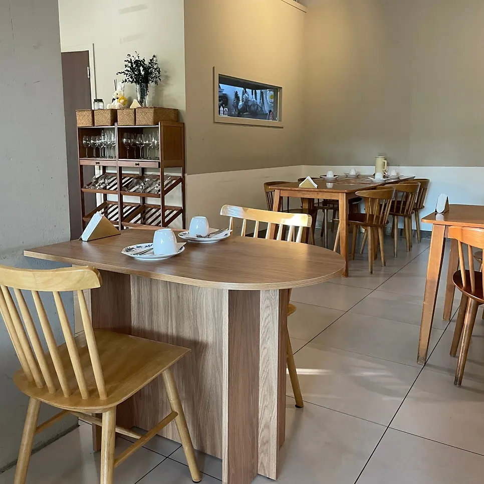 Interior of Le Garden Bleu with wood tables