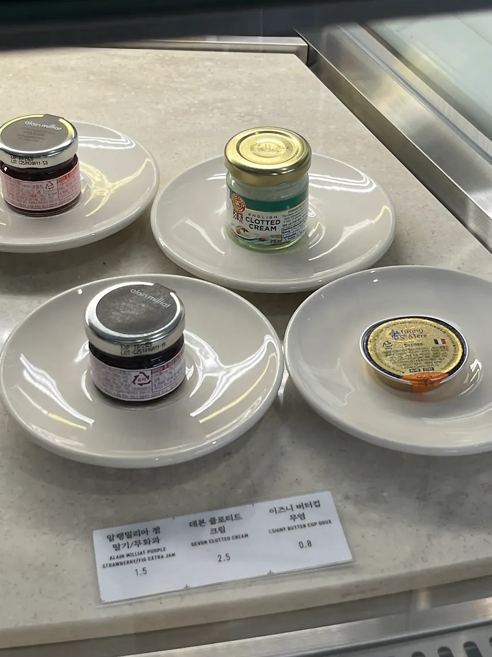 Jam, clotted cream, and Isigny butter served as accompaniments