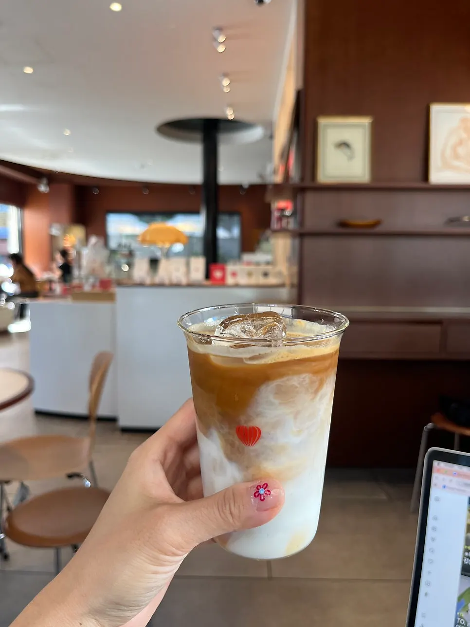 A cup of latte captured with the store's atmosphere