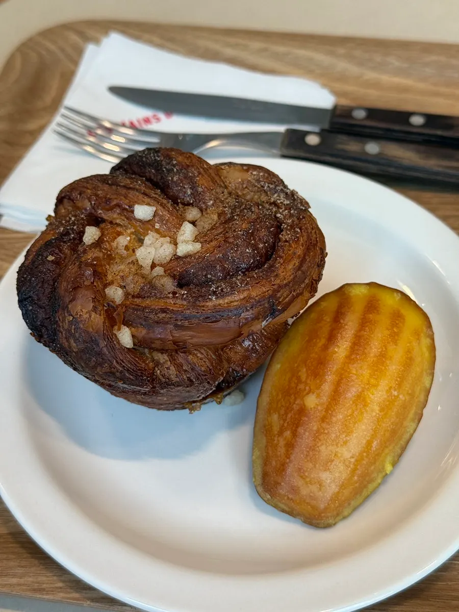 Cardamom bun and madeleine served alongside coffee