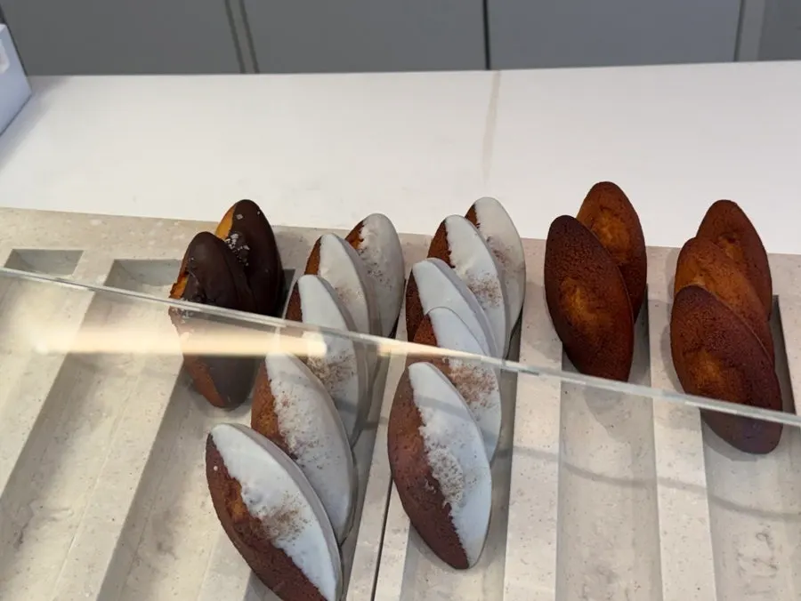 Display case with chocolate baguettes and other breads