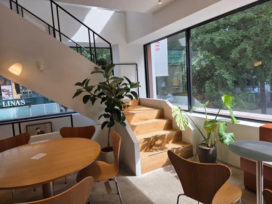 2nd floor seating lit up by the floor-to-ceiling window