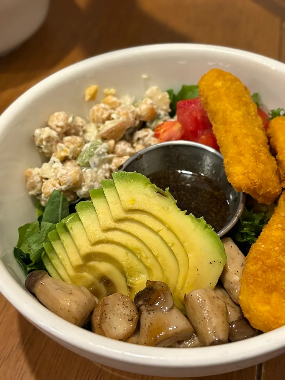 Two poke bowls and a glass of green smoothie