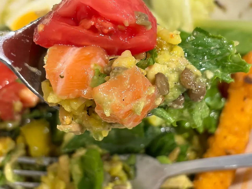 A spoonful of salmon and leafy greens together