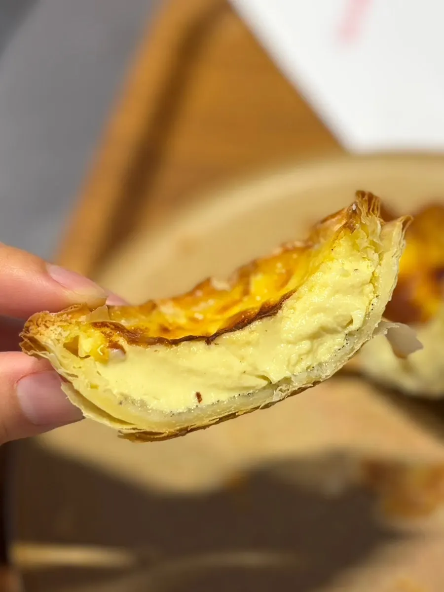 Cross-section of egg tart showing crisp pastry layers