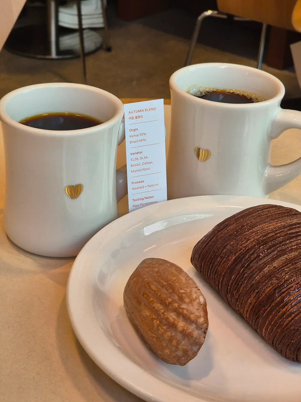 Pain au chocolat and vanilla madeleine with coffee set up