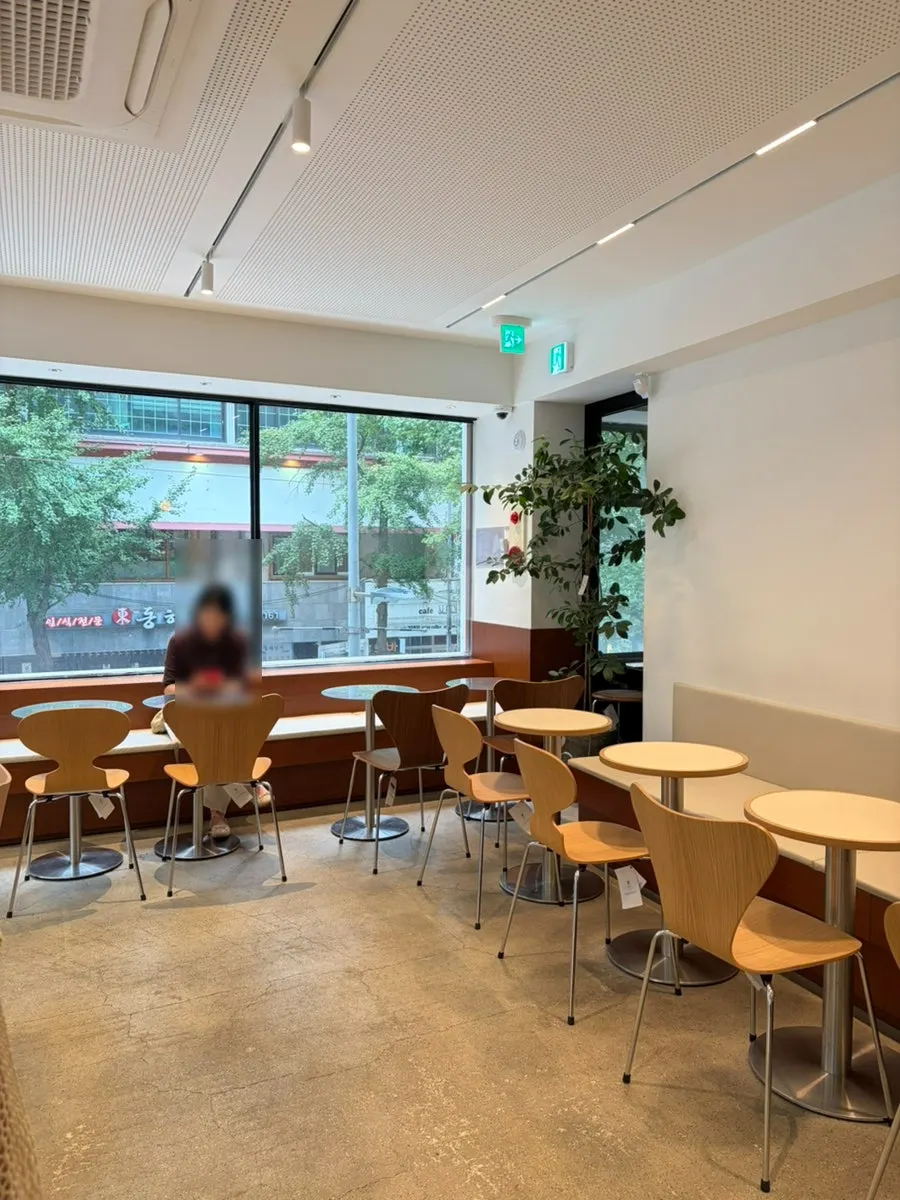 2nd-floor table area with floor-to-ceiling windows