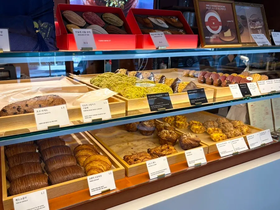 Croissants and pastries on display shelf