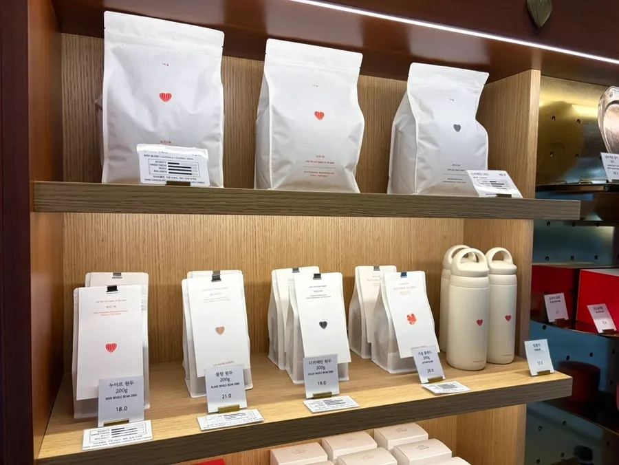 Shelf with coffee beans and tumblers