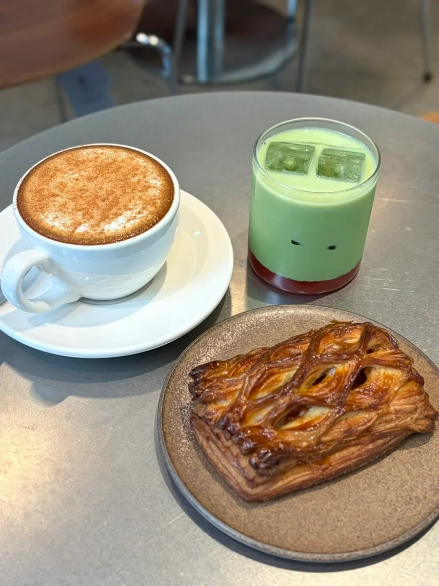 Table setup with chausson aux pommes, cappuccino, and Noorwegian Forest