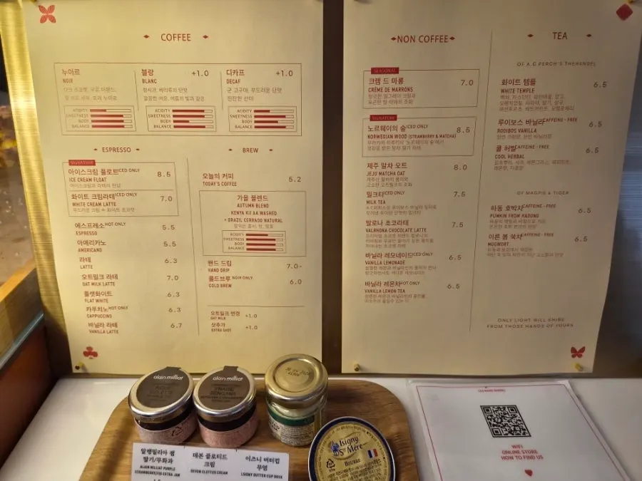 Coffee menu board listing lattes and hand-drip