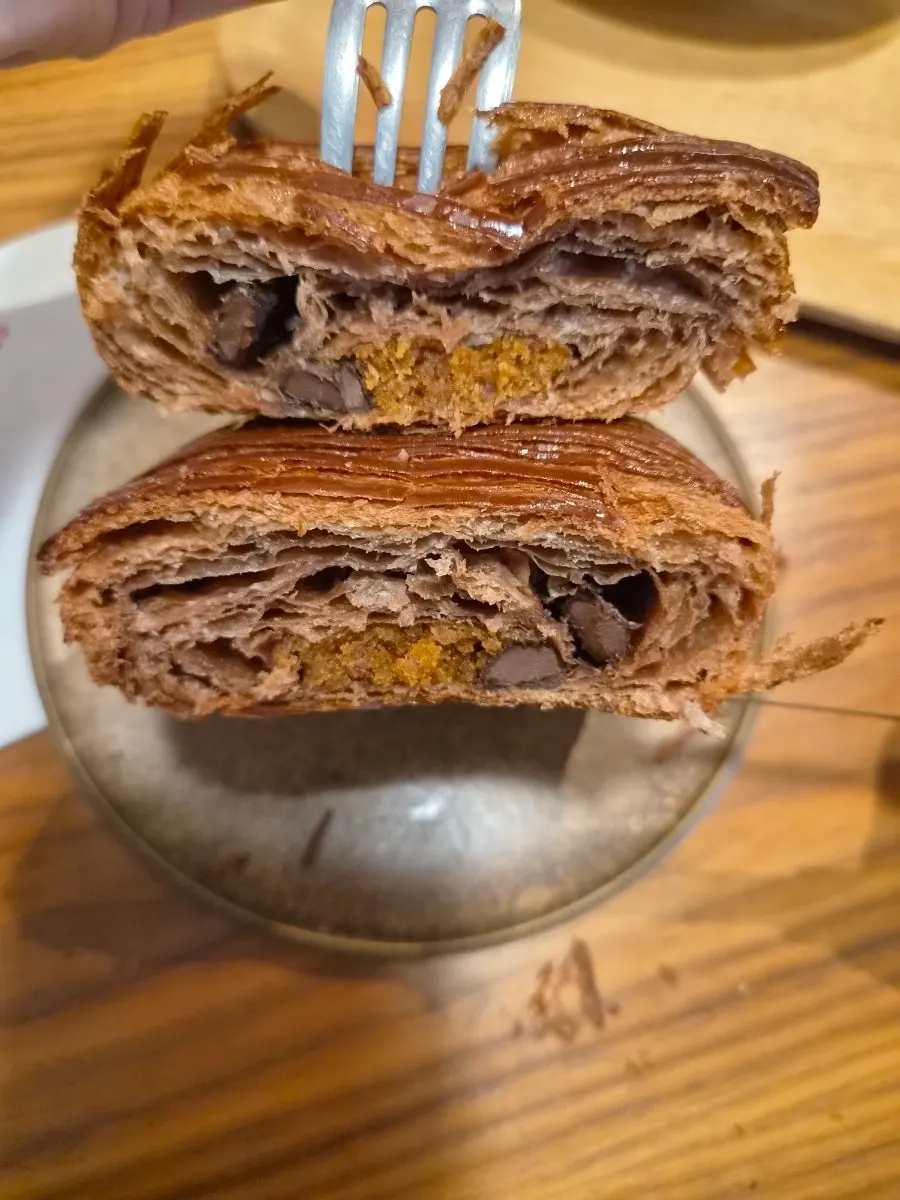 Pain au chocolat cut with a fork showing the chocolate inside