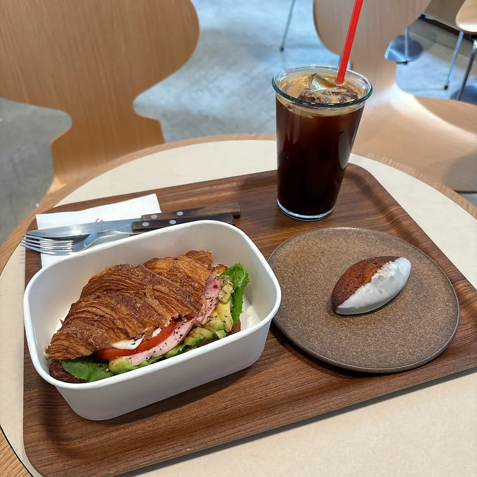Croissant sandwich and nutmeg financier table setting