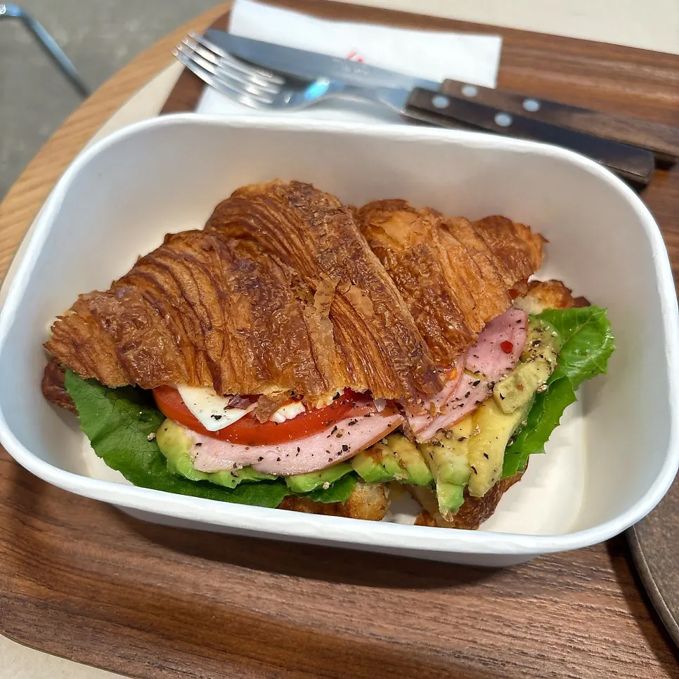 Croissant sandwich with ham, cheese and avocado