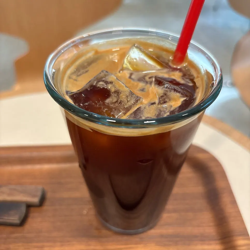 Iced americano placed alongside the sandwich