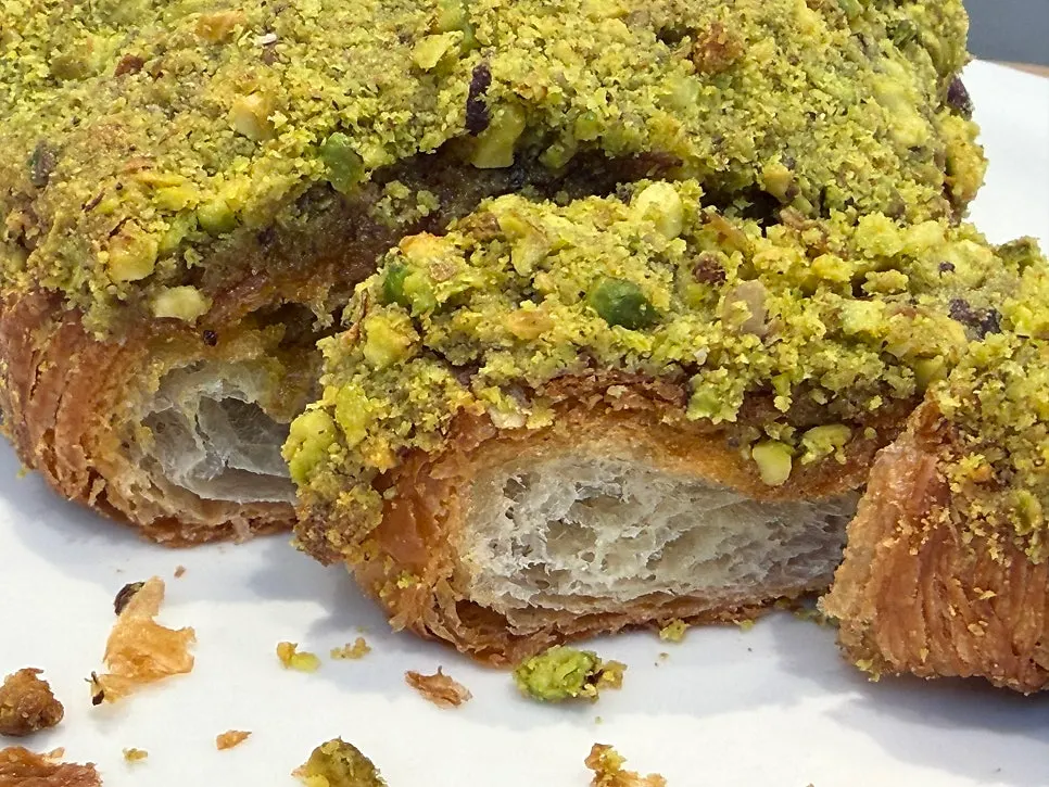 Drinks and pistachio croissant on the table