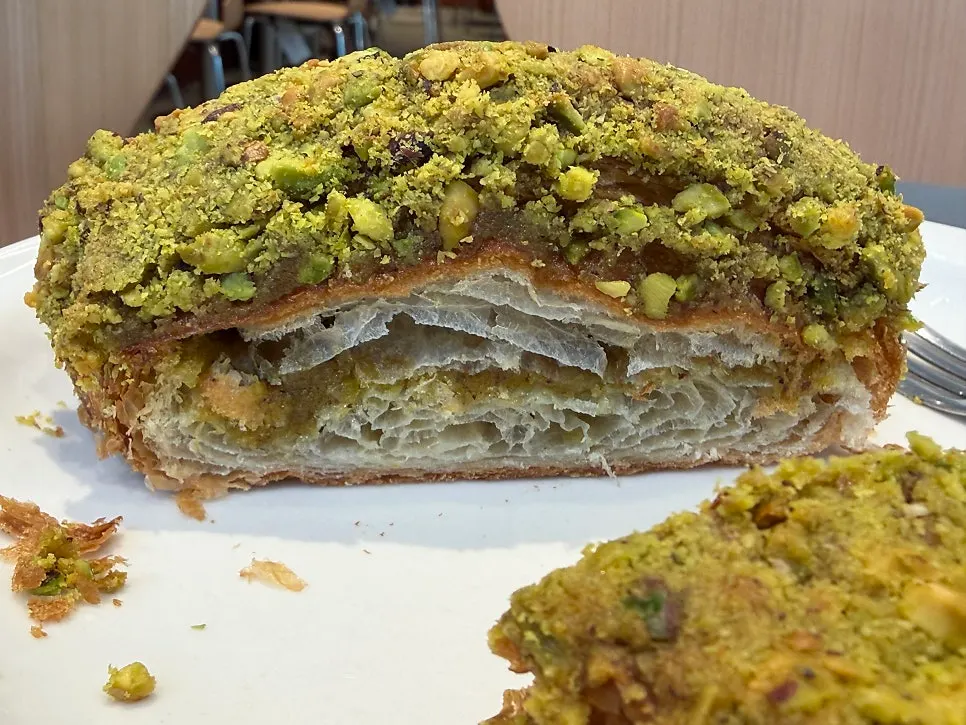 Croissant topped with pistachio bits