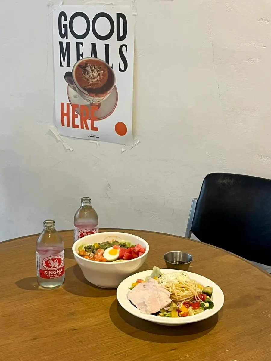 Salmon avocado poke bowl and salad pasta served together