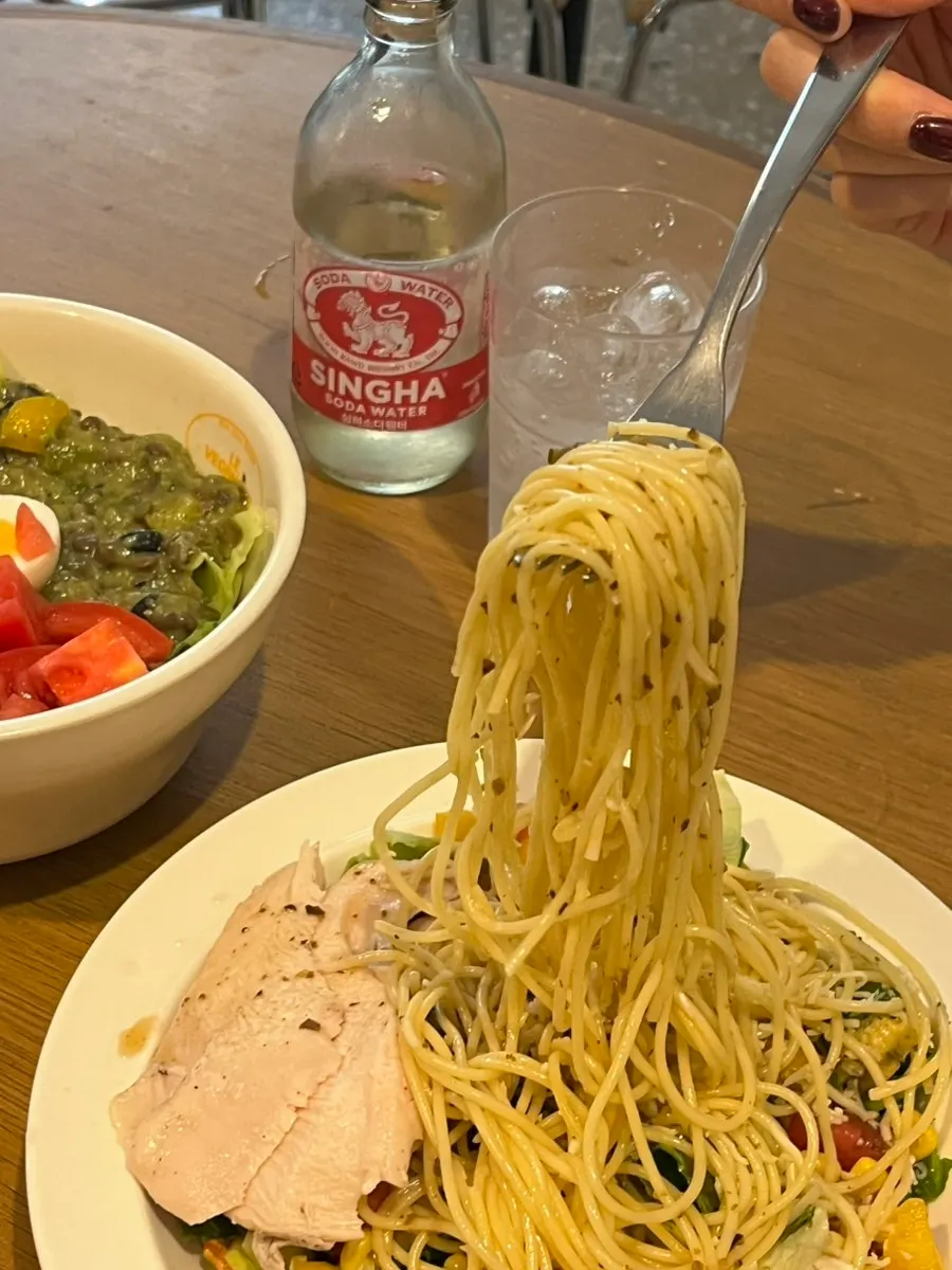 Poke bowl and salad pasta placed together on the table