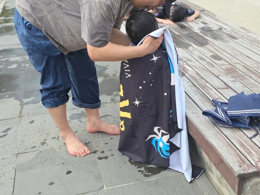Child wet from playing in a park fountain