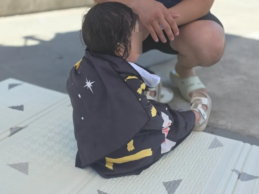 Large beach towel wrapped generously around a child