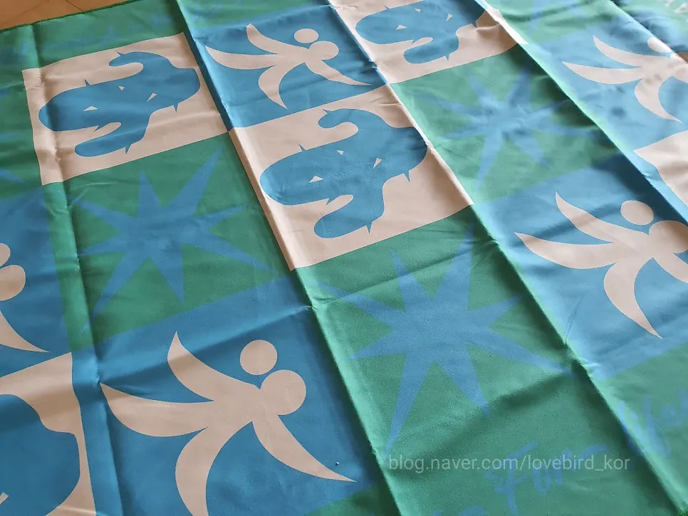 Large beach towel folded for packing in a travel bag