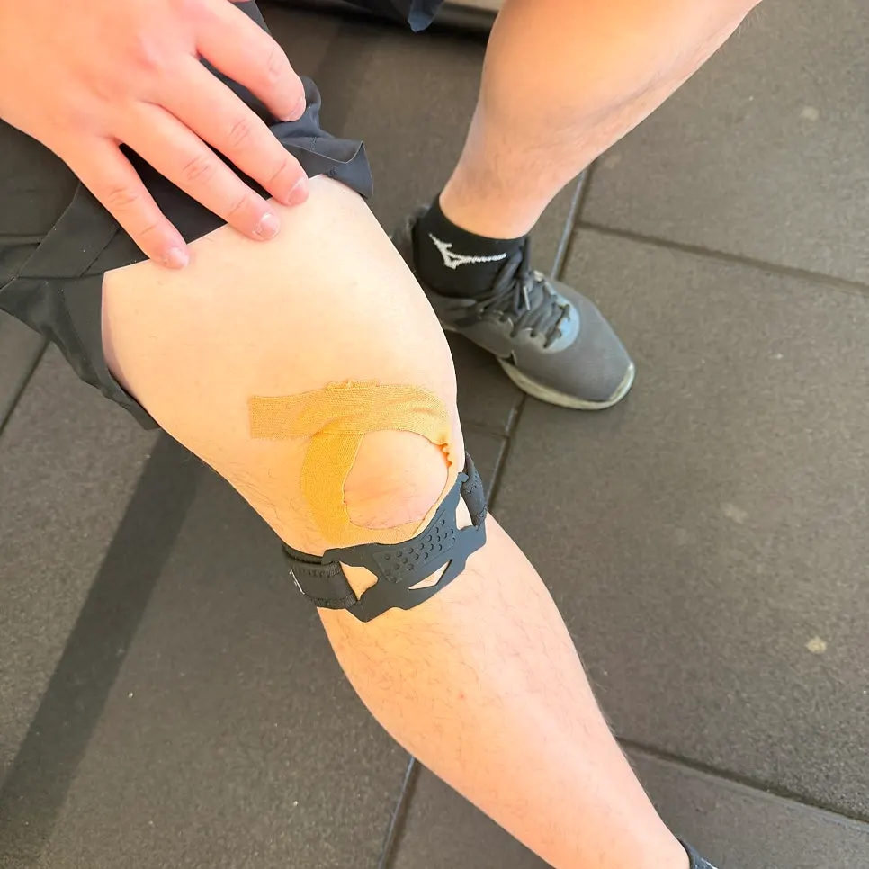 Squatting while wearing the knee support