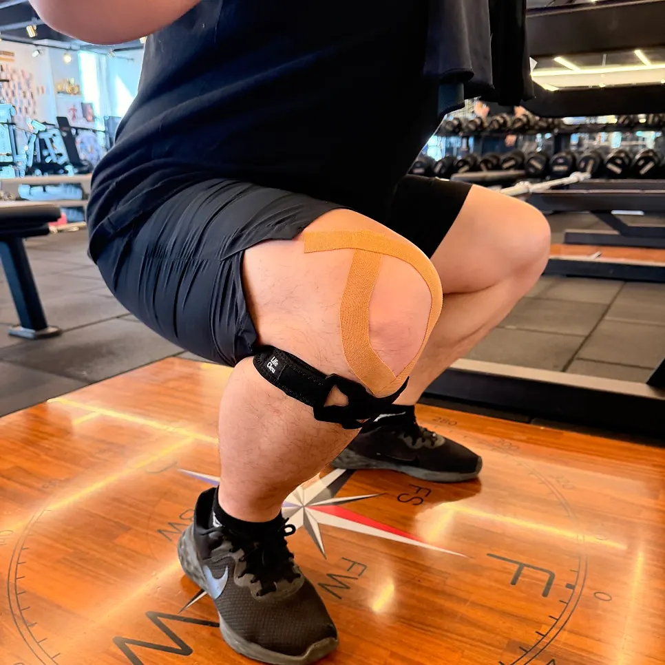 My husband doing squats while wearing the knee support