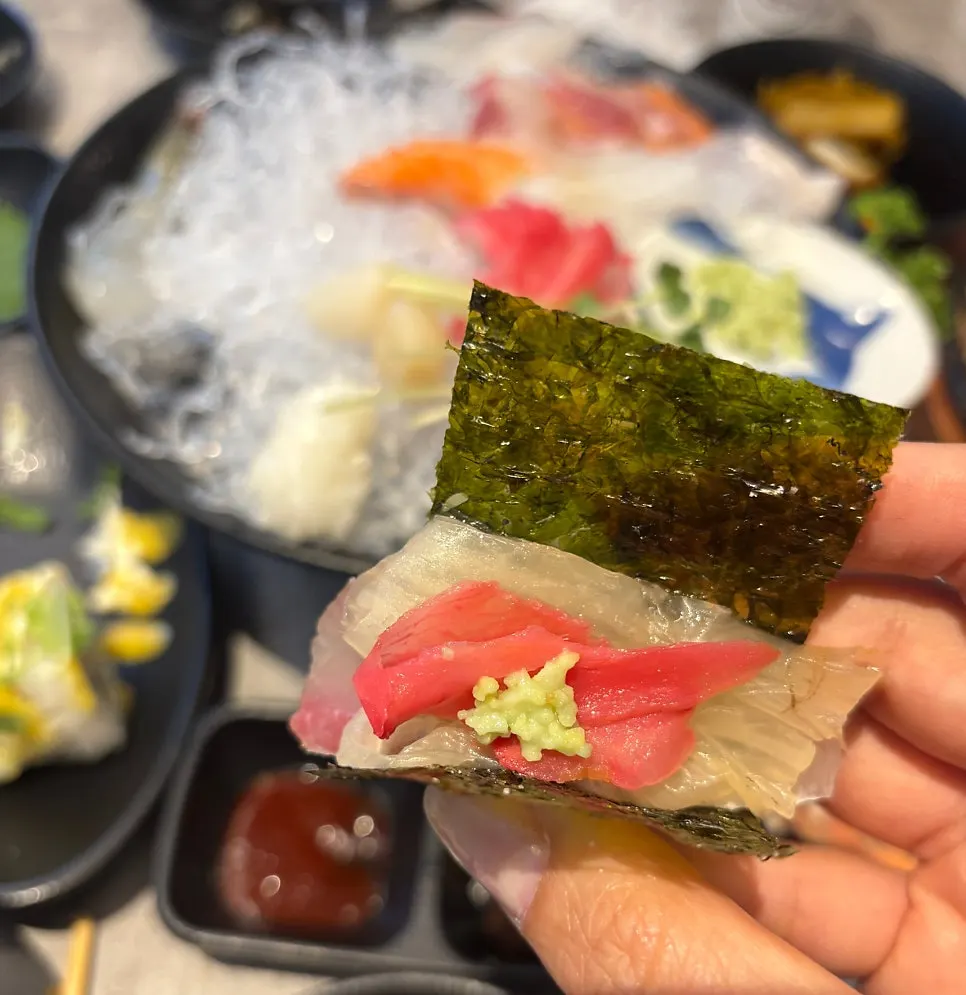A slice of aged sashimi cut to just the right thickness