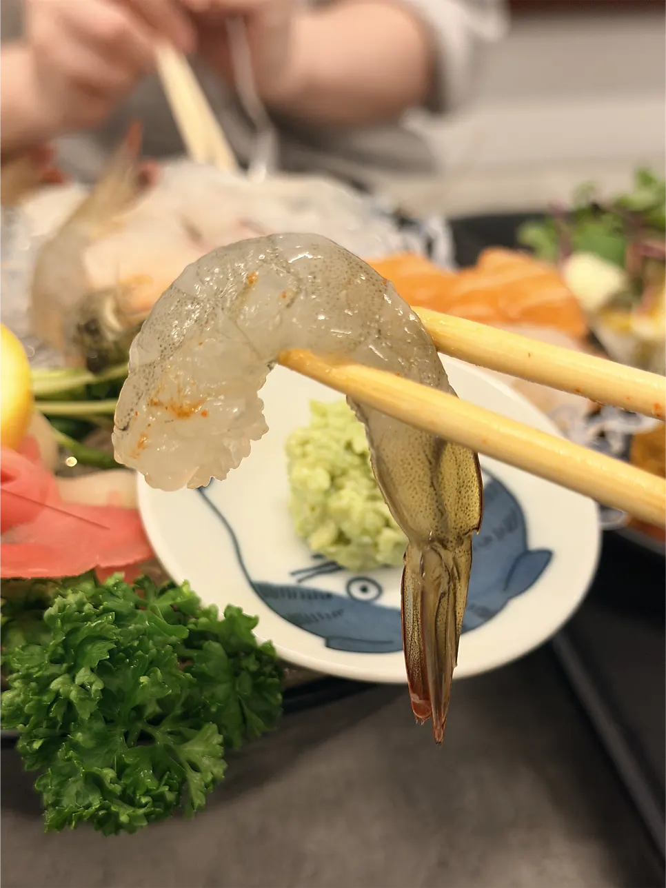 Aged sashimi eaten with soy sauce, wasabi, and seaweed wrap