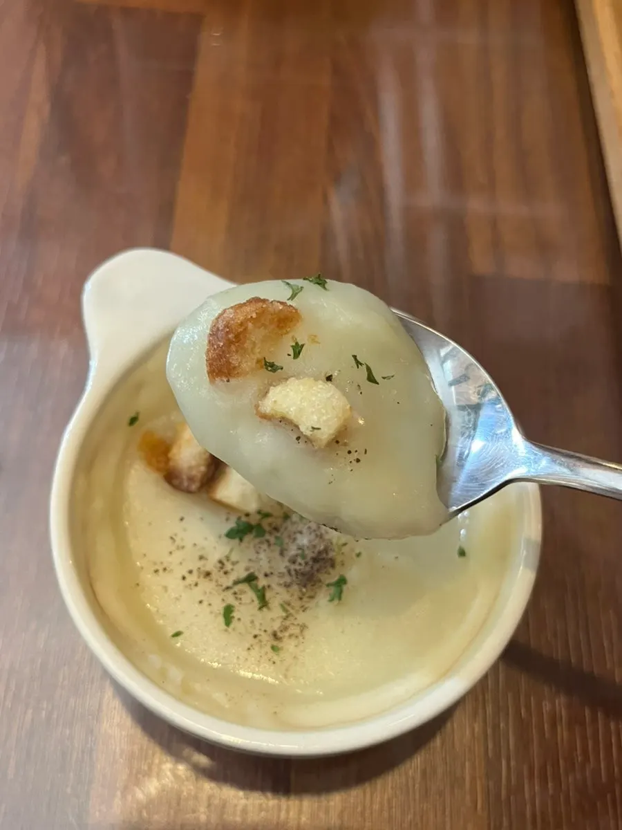 Spooning up the thick potato cream soup