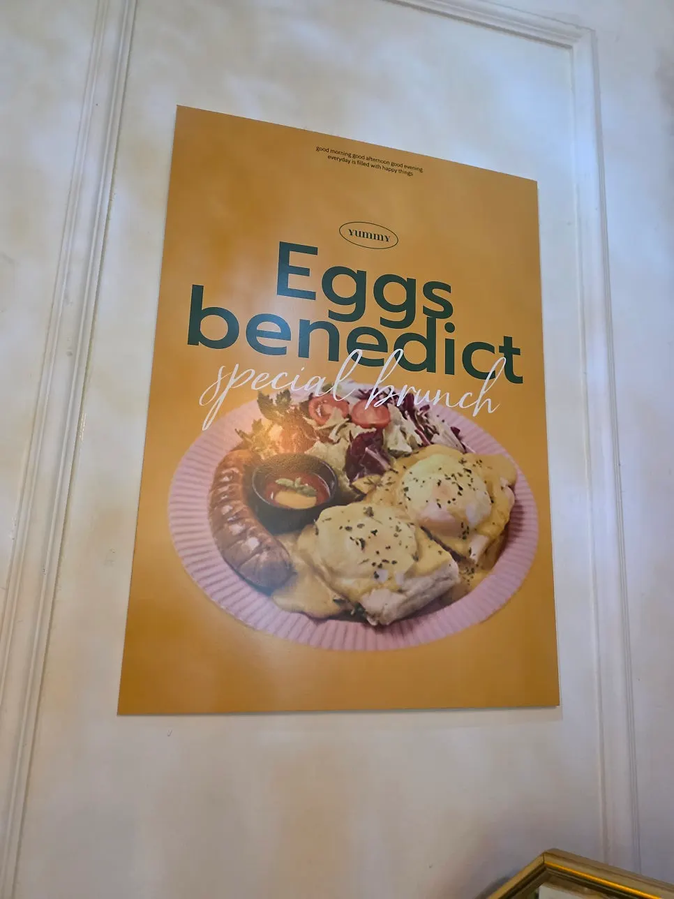 Menu board listing prices for the French toast plate and egg Benedict