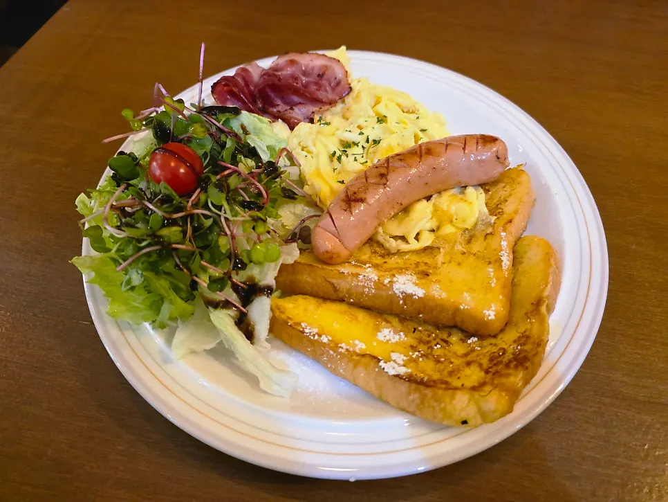 A plate with French toast, bacon and sausage together