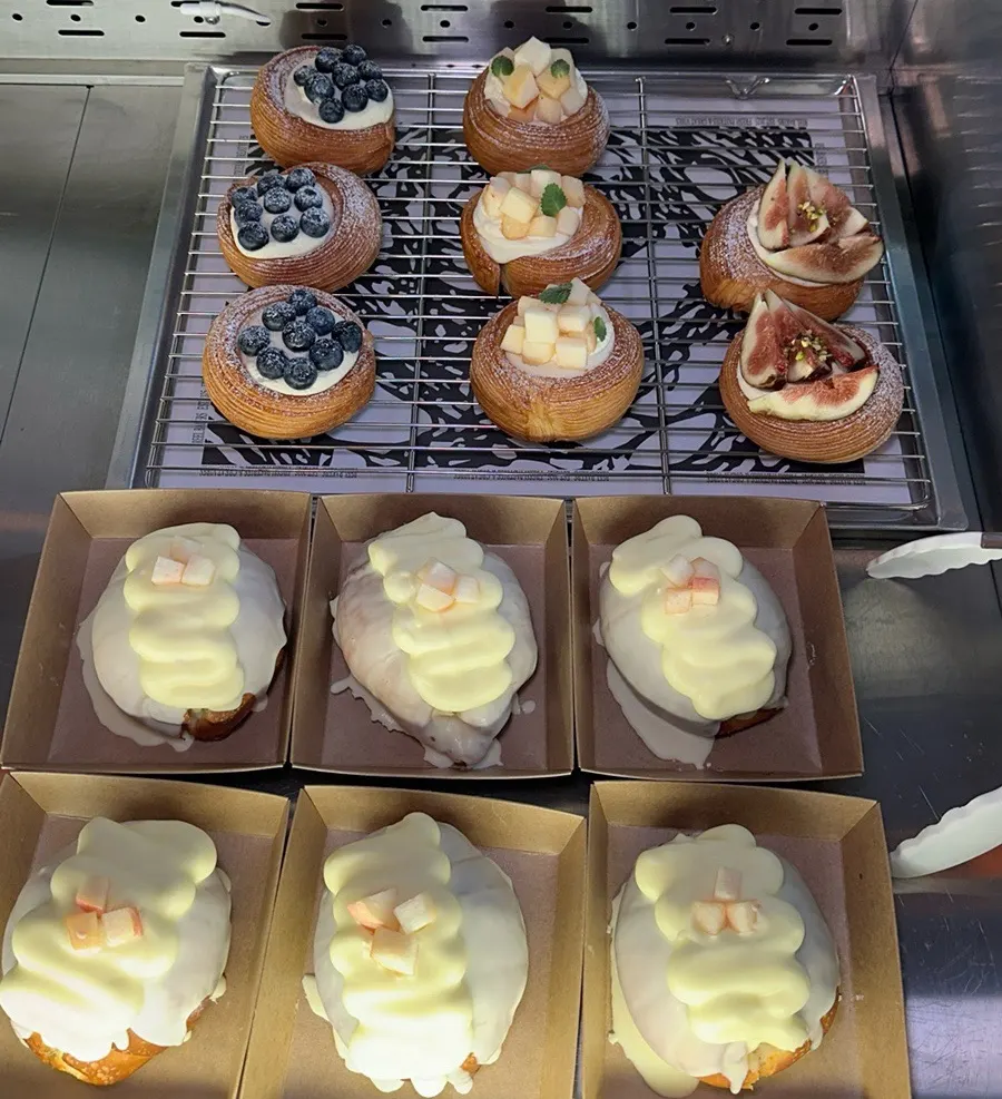 Danishes and peach wakku salt bread in the showcase